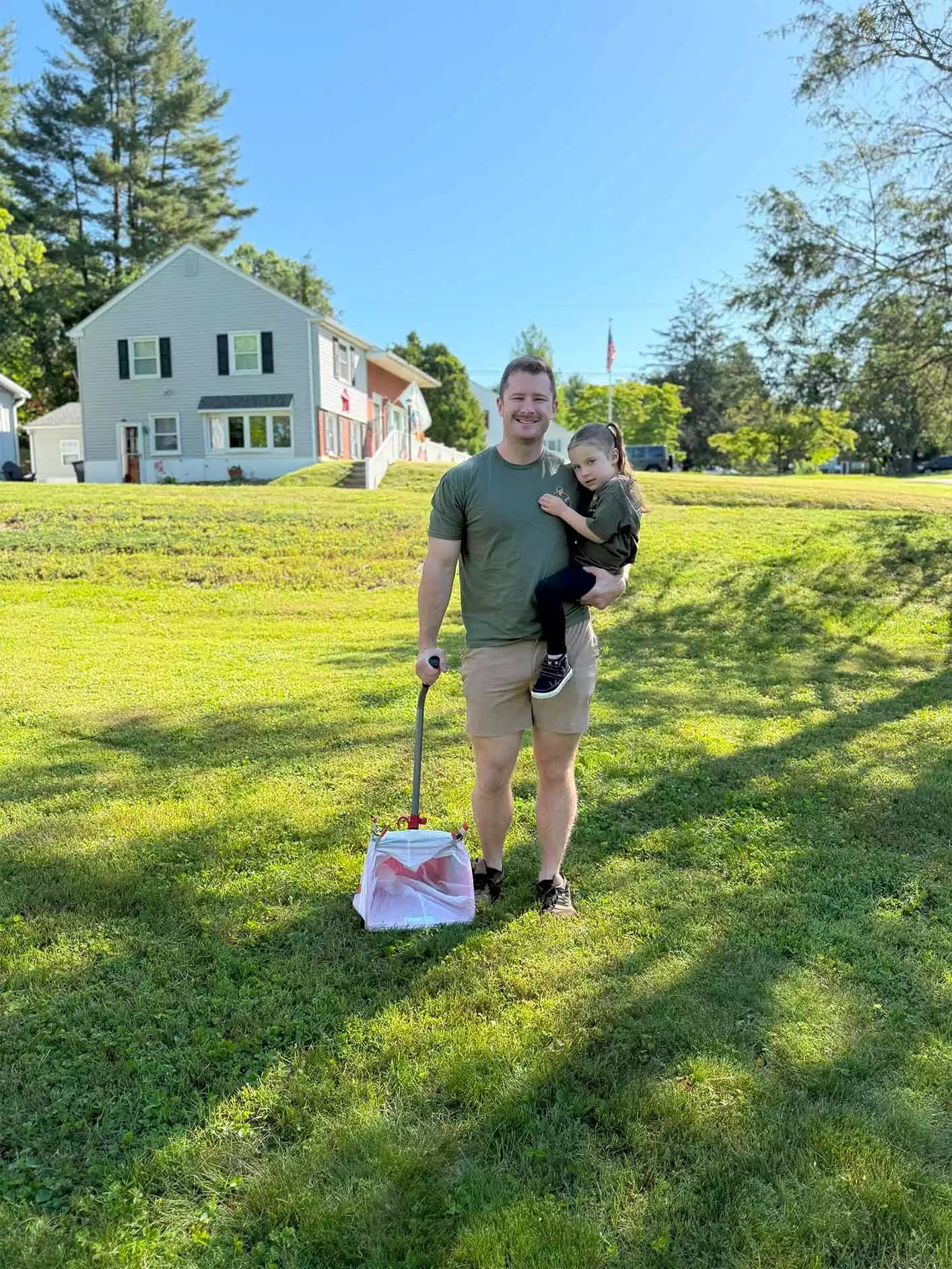Poop Daddy with professional scooping equipment and his daughter